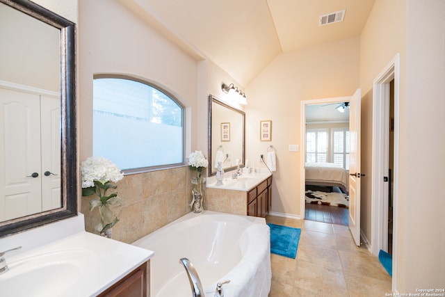 bathroom with plenty of natural light, vanity, ceiling fan, and vaulted ceiling