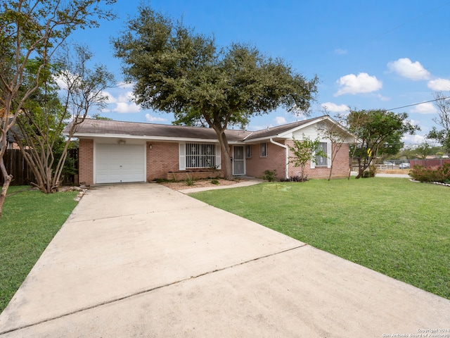 single story home with a garage and a front yard