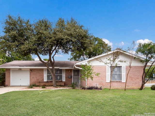 ranch-style home with a garage and a front yard