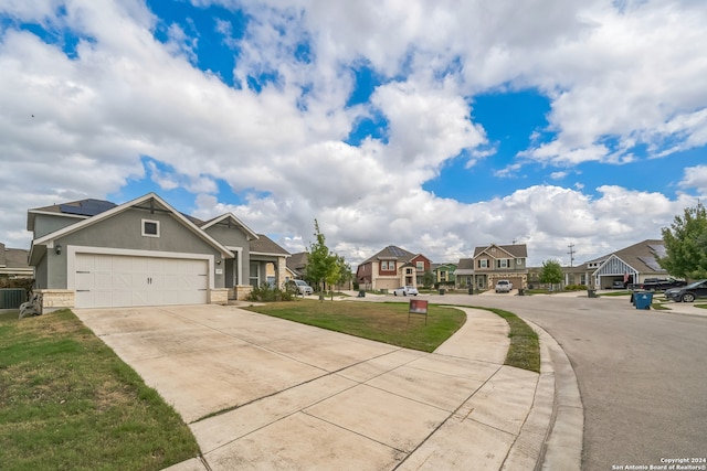 view of front facade with a front yard and a garage