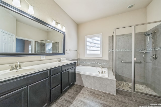 bathroom featuring independent shower and bath and vanity