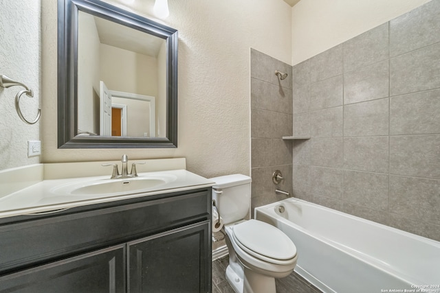 full bathroom featuring vanity, toilet, and tiled shower / bath combo