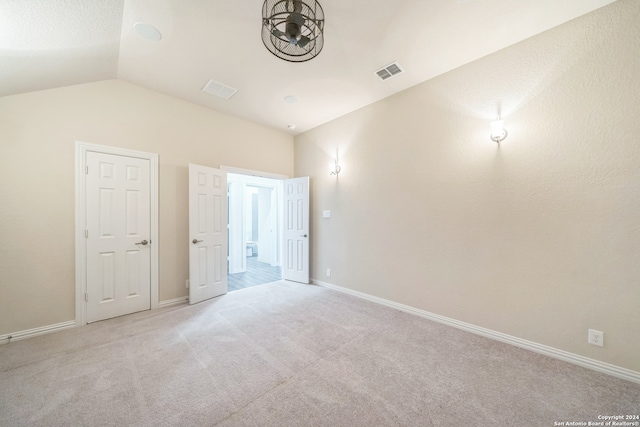 interior space with light colored carpet and lofted ceiling