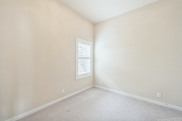 unfurnished room with light carpet