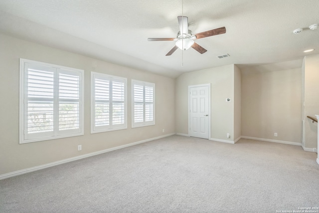 carpeted empty room featuring a textured ceiling and ceiling fan