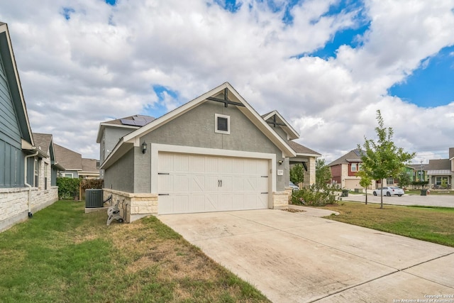 12009 Vignette, Schertz, TX 78154 - view of front facade featuring stone siding, a front yard, stucco siding, driveway, and central AC
