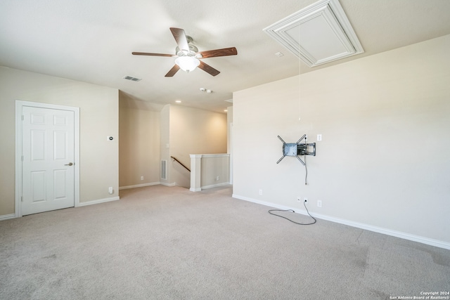 empty room with ceiling fan and light colored carpet