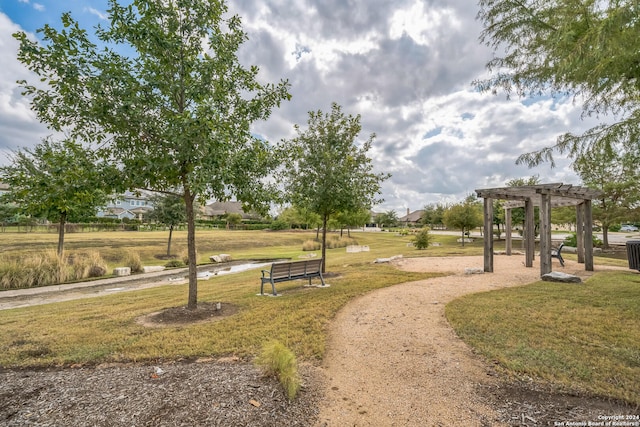 view of community with a pergola and a lawn