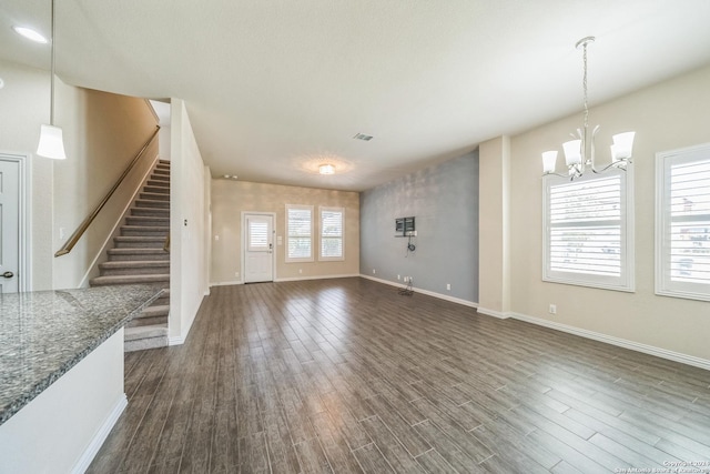 12009 Vignette, Schertz, TX 78154 - unfurnished living room featuring a chandelier, dark wood-style flooring, stairway, and baseboards