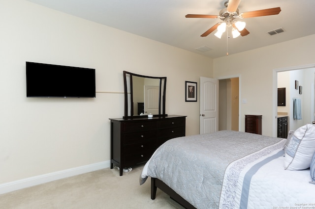 carpeted bedroom featuring ceiling fan and ensuite bath