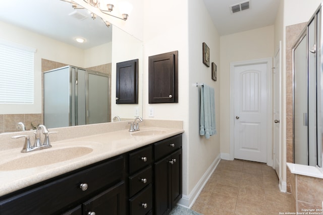 bathroom featuring vanity, tile patterned floors, and a shower with shower door