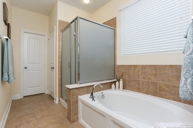 bathroom featuring tile patterned flooring and shower with separate bathtub