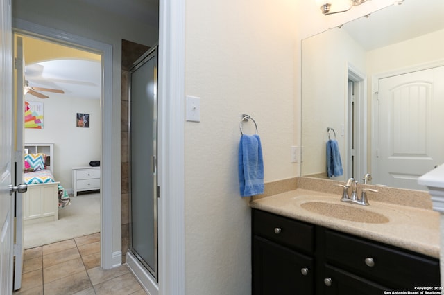 bathroom featuring vanity, ceiling fan, tile patterned floors, and a shower with shower door