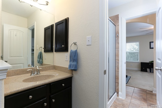 bathroom featuring an enclosed shower, vanity, ceiling fan, and tile patterned floors