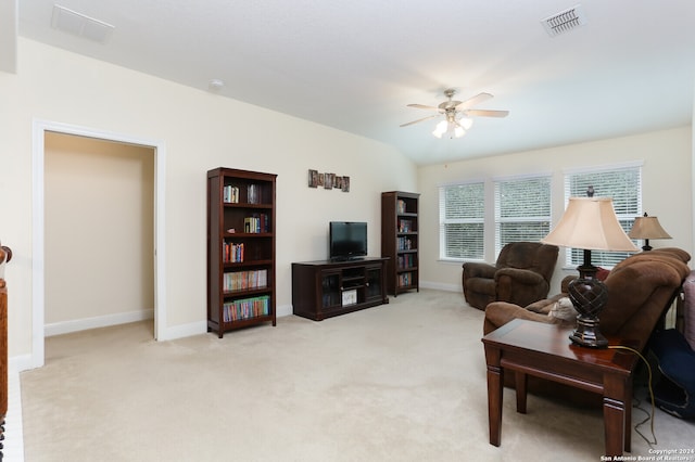 carpeted living room featuring ceiling fan and vaulted ceiling