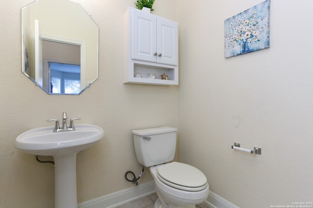 bathroom featuring tile patterned flooring, sink, and toilet