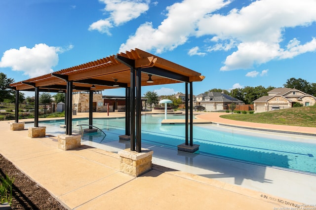 view of swimming pool with ceiling fan and a patio