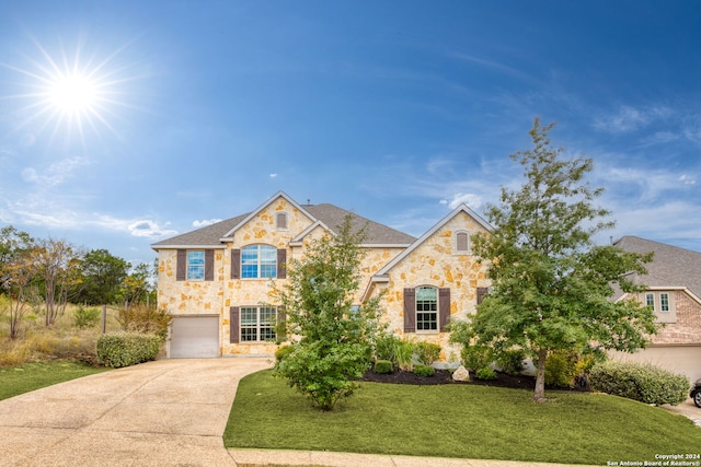 view of front facade featuring a front lawn and a garage