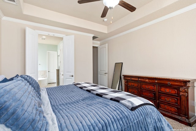 bedroom with carpet floors, ceiling fan, crown molding, and a tray ceiling