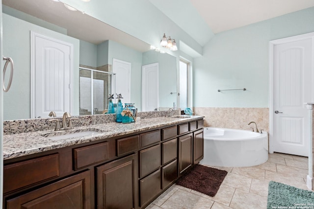 bathroom with tile patterned flooring, vanity, vaulted ceiling, and plus walk in shower