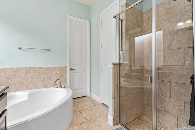 bathroom with independent shower and bath, vanity, and tile patterned floors