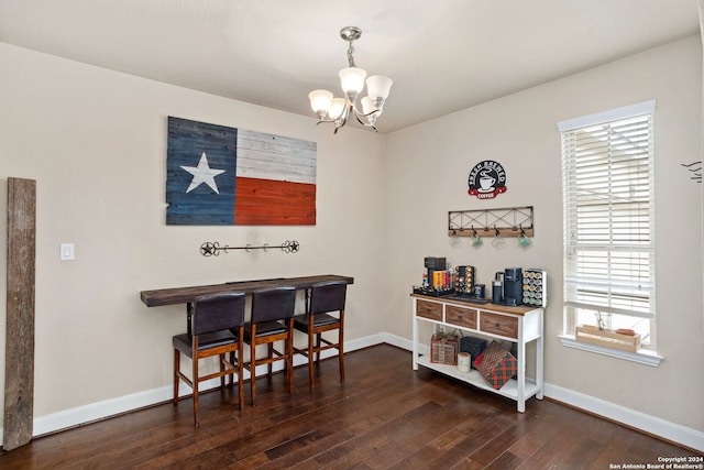 dining area featuring dark hardwood / wood-style flooring and a chandelier