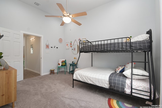 carpeted bedroom featuring a high ceiling and ceiling fan