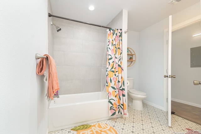 bathroom featuring electric panel, shower / bath combo, and toilet