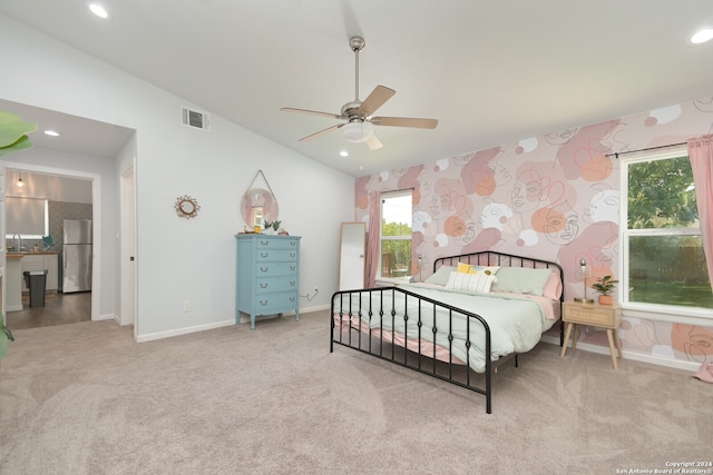 bedroom featuring light colored carpet, ceiling fan, vaulted ceiling, and stainless steel fridge