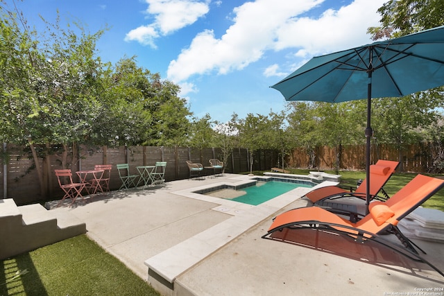 view of pool featuring a hot tub, a patio, and a diving board