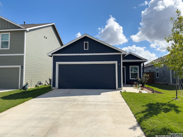 view of front of property with a front yard and a garage