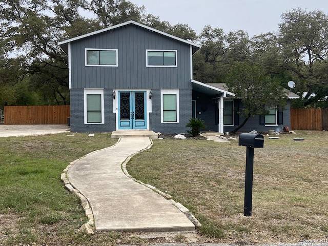 view of property featuring a front lawn