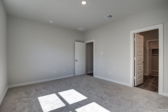 unfurnished bedroom featuring dark colored carpet