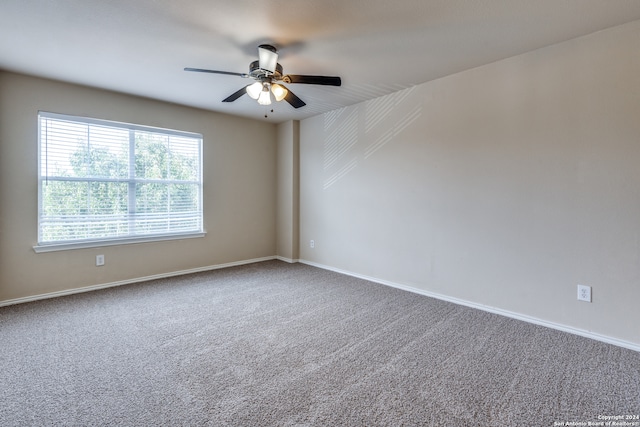 empty room featuring carpet floors and ceiling fan