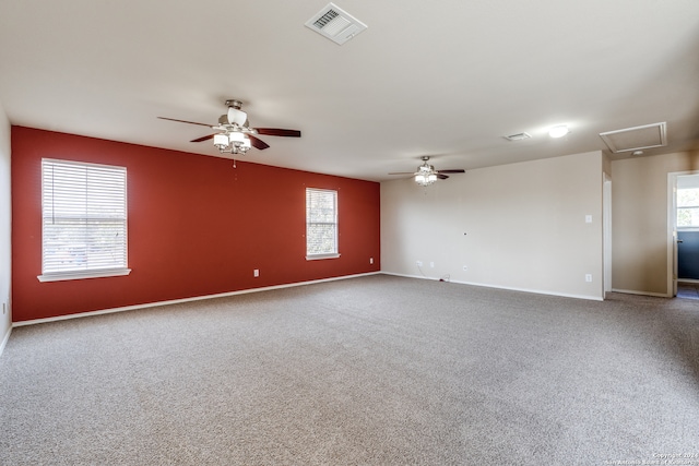 carpeted spare room featuring plenty of natural light and ceiling fan