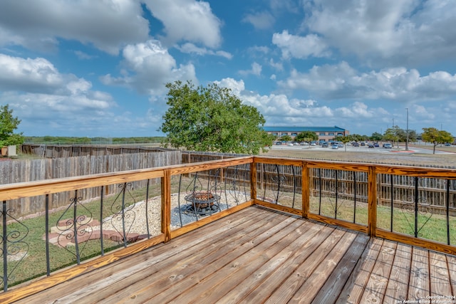 wooden deck featuring a lawn