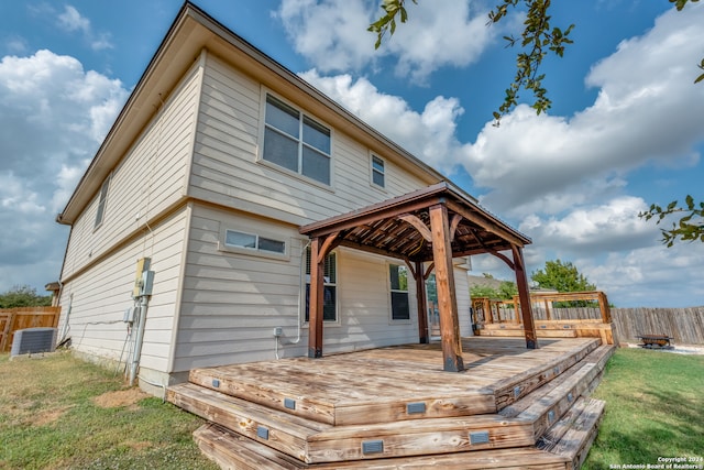 back of property with central AC unit, a yard, a gazebo, and a deck