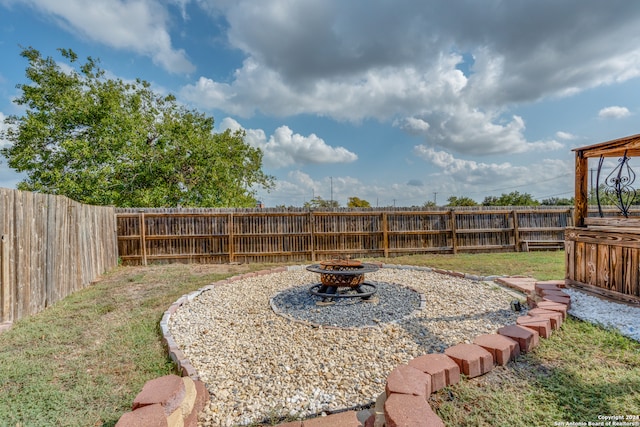 view of yard with a fire pit