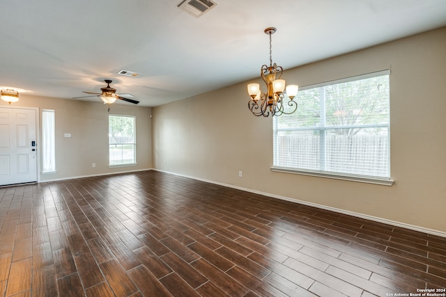 unfurnished room featuring dark wood-type flooring and ceiling fan with notable chandelier