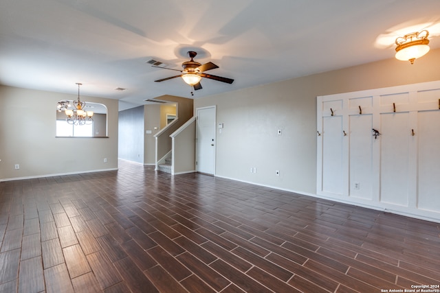 unfurnished room featuring ceiling fan with notable chandelier and dark hardwood / wood-style flooring