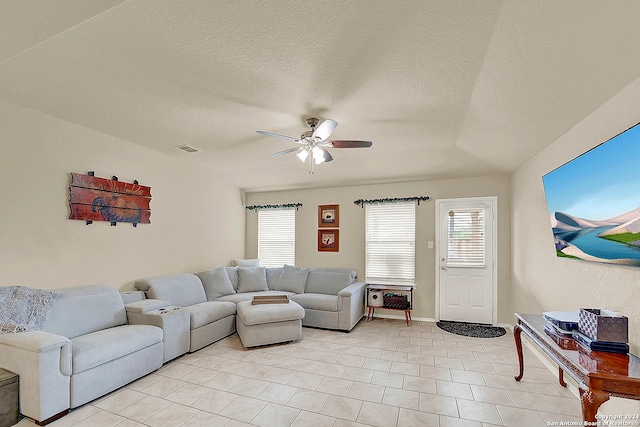 living room with a textured ceiling and ceiling fan