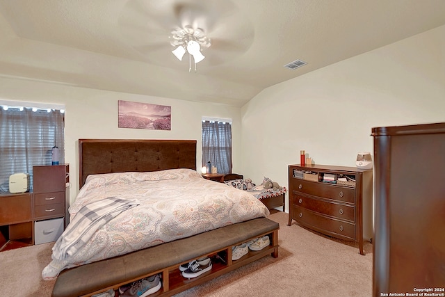 carpeted bedroom featuring vaulted ceiling and ceiling fan