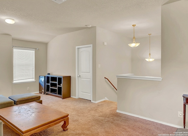 carpeted living room featuring vaulted ceiling and a textured ceiling