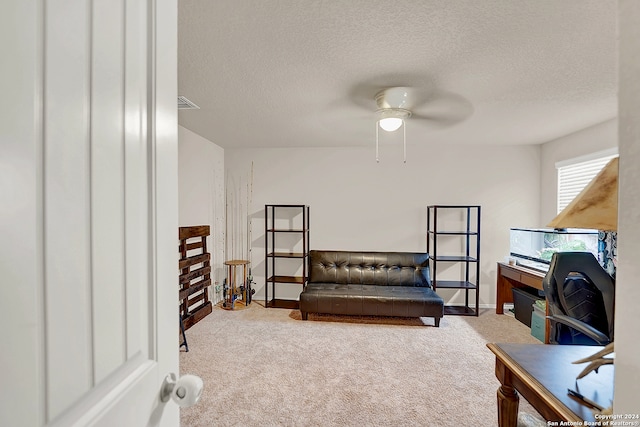 bedroom featuring a textured ceiling, ceiling fan, and carpet floors