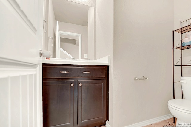 bathroom featuring toilet, vanity, and tile patterned floors