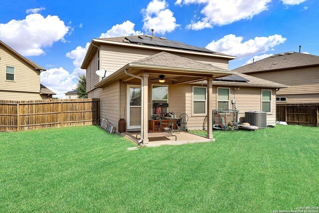 10055 Strasbourg Way, Schertz, TX 78154 - back of property featuring cooling unit, a patio, roof mounted solar panels, and a ceiling fan