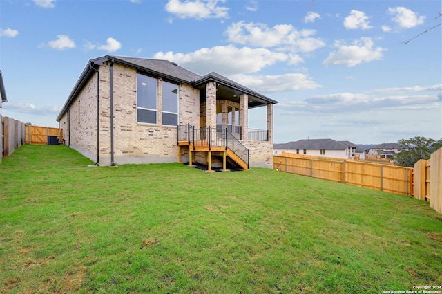 rear view of property featuring a yard