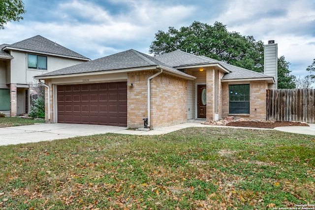 view of front of house with a garage and a front yard