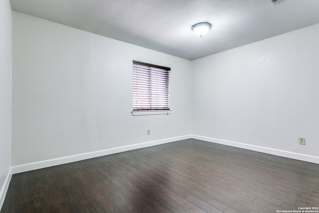 empty room with dark wood-type flooring