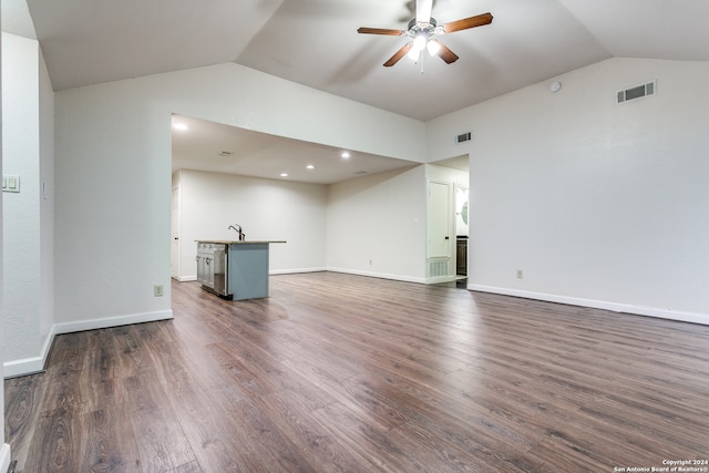 unfurnished living room featuring dark wood-type flooring, ceiling fan, lofted ceiling, and sink